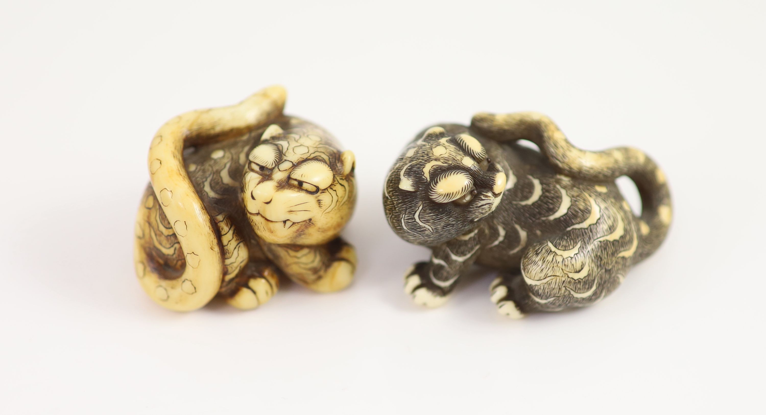 Two Japanese ivory netsuke of a tiger, Edo period, first half 19th century, 4cm and 5cm